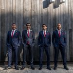 Tailored navy blue suits with red silk ties